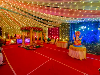 Wedding mandap decoration with floral pillars and Ganesh idol under LED fairy lights for traditional event in Behala, Kolkata