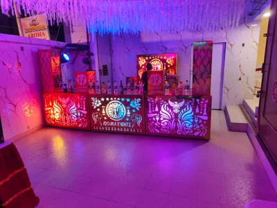 Illuminated mocktail bar counter with colorful LED lighting and decorative panels for wedding event at banquet hall in Behala, Kolkata